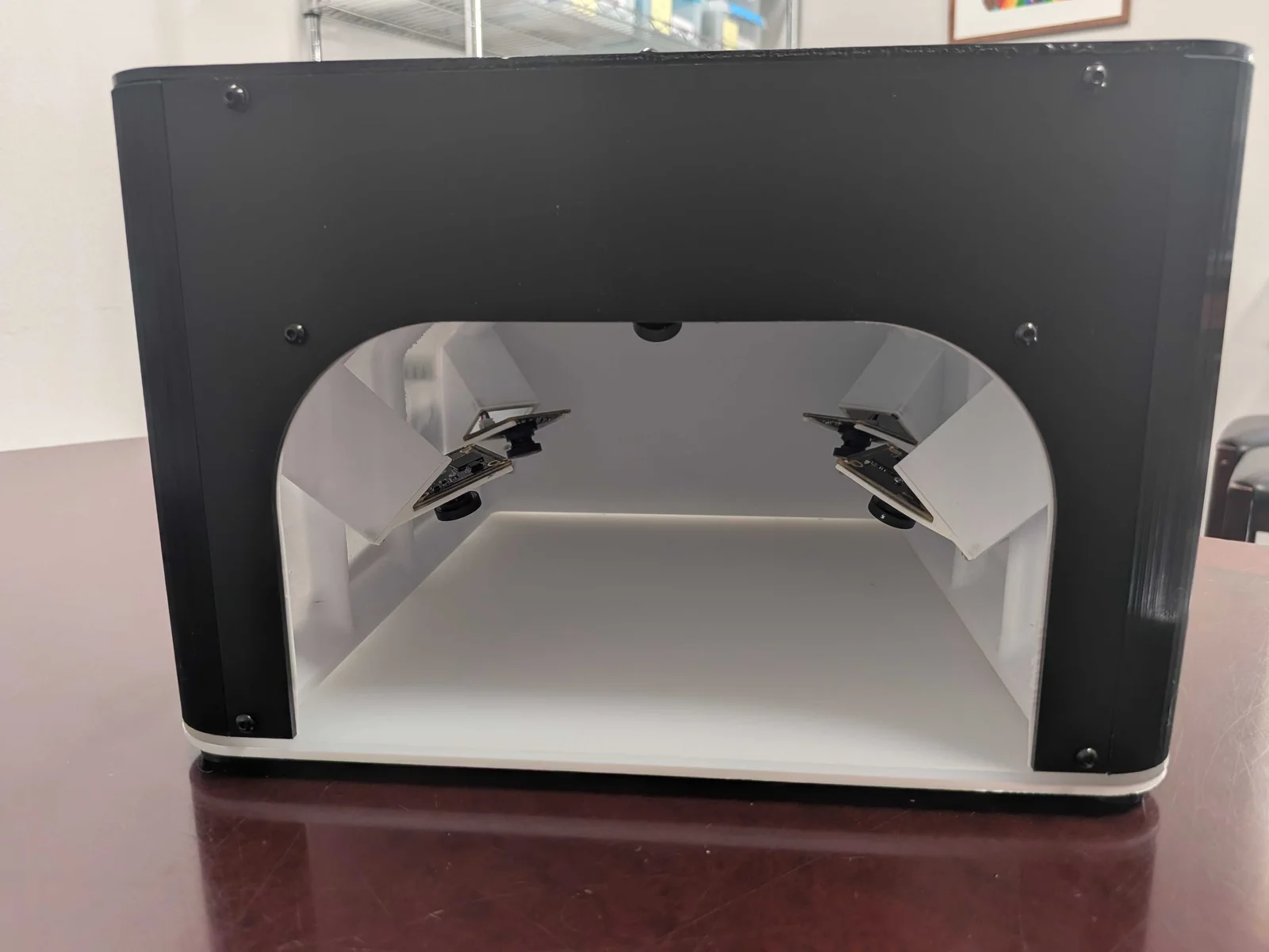 Interior of the photobox showing six cameras aimed toward the central product area