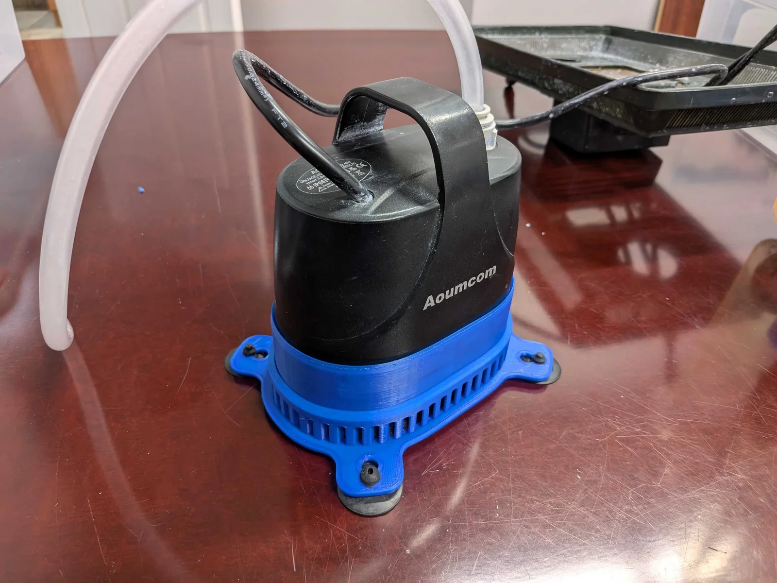 Polisher pump seated inside the blue printed pre-filter housing