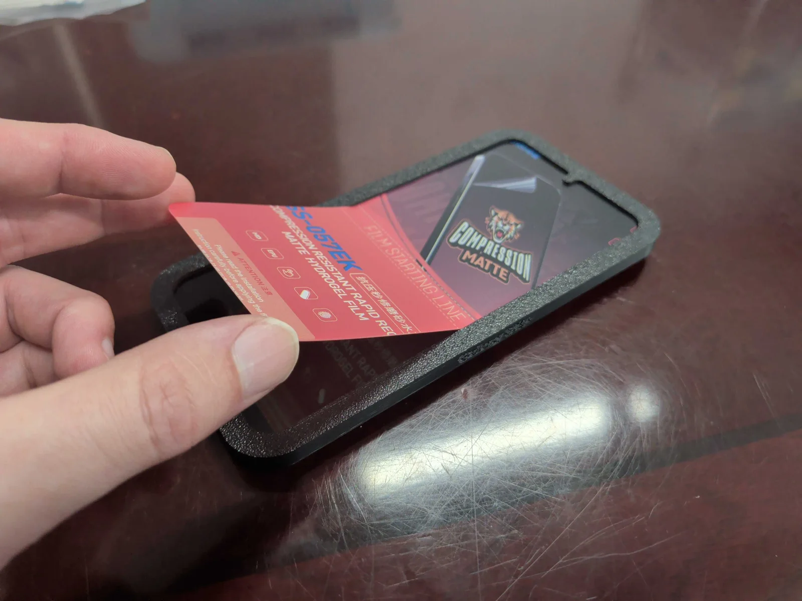 Screen protector being aligned onto a phone through the printed guide